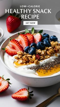 a bowl filled with yogurt and fruit on top of a white table next to strawberries