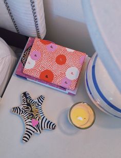 a close up of a star shaped object on a table next to a candle and other items