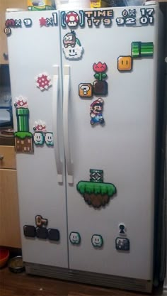 a white refrigerator covered in stickers and magnets