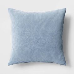 a blue pillow sitting on top of a white wall