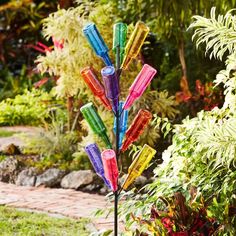 a multicolored glass wind chime in a garden