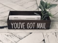 a wooden box with a plant in it that says, you've got mail