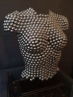 a sculpture made out of metal balls on display