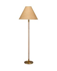 a floor lamp with a beige shade on it