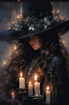 a woman with long hair wearing a witches hat and holding candles in front of her face