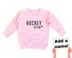 Hockey sis sweatshirt with option to add last name  All sweatshirts are made with a lightweight unisex style pullover.  The toddler sizes run from 2T to a size 7 and they are Rabbit Skins brand.  The 5/6 tends to fit a little more closely to a 6 in my experience.  The youth sizes are made with Gildan brand sweatshirts and run from youth small to youth XL. SHIPPING: All orders will be shipped using USPS ground shipping (2-5 business days) unless you have upgraded. I always aim to get your items o Hockey Sister Shirts, Hockey Sister Sweatshirt, Hockey Sister, Hockey Crafts, Brand Sweatshirts, Hockey Sweater, Hockey Sweatshirts, Hockey Gifts, Billings Mt