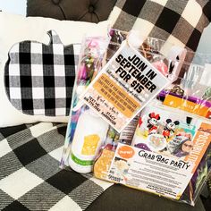 an assortment of items sitting on top of a black and white checkered couch next to a pillow