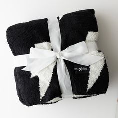 a black and white blanket with a bow on it