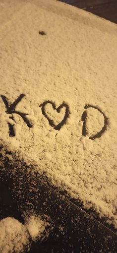 the word go written in snow on top of a car