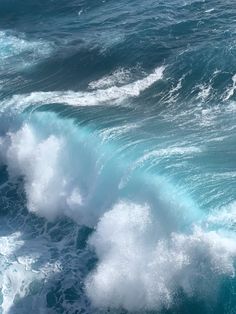 an ocean wave with white foam and blue water