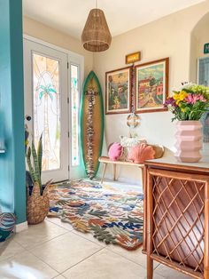 a living room with surfboards on the wall and rugs in front of it