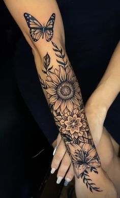 a woman's arm with sunflowers and butterflies on it