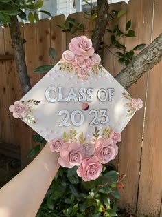 someone is holding up a graduation cap decorated with flowers and the words class of 205