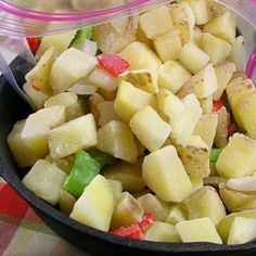 a bowl filled with potatoes and green peppers