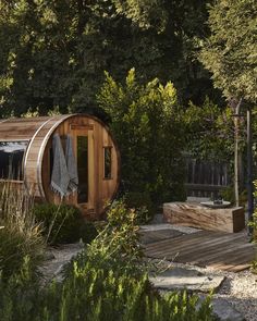 an outdoor sauna in the middle of some trees