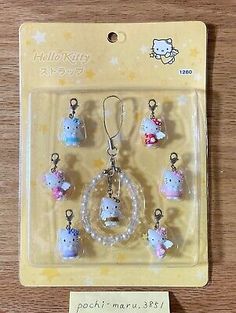 hello kitty keychain and charm set in plastic package with tags on the front