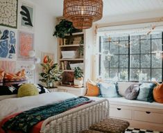 a bedroom with a bed, window seat and lots of decorations on the wall above it