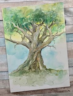 a watercolor painting of a tree with green leaves on the top and blue sky in the background