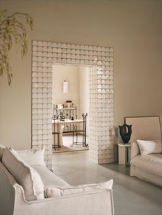 a living room filled with furniture and decor on top of a white tile flooring