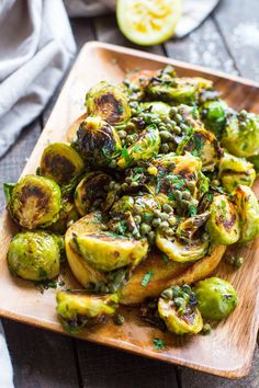 brussel sprouts and brussels sprouts on a wooden cutting board