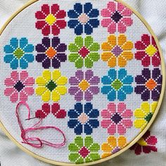 a cross stitch pattern with colorful flowers on it