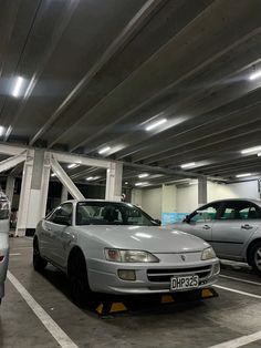 two cars are parked in a parking garage