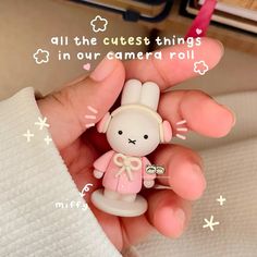 a person holding a small toy in their hand with the caption all the cutest things in our camera roll