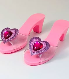 a pair of pink shoes with hearts on them