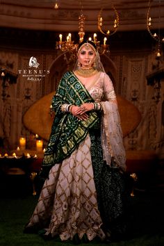 a woman in a green and white wedding outfit