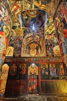 the interior of an old church with paintings on it