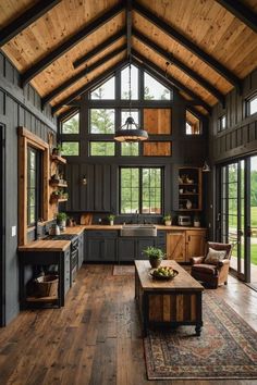 a large open concept kitchen with wood flooring and vaulted ceiling, along with an area rug on the hardwood floor