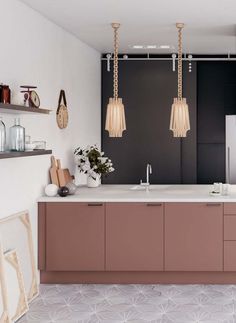 a kitchen with two hanging lights above the sink