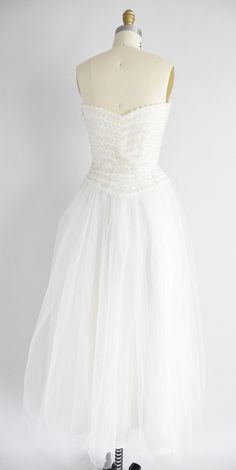 "Vintage 1950s brilliant white tulle dress. Sweetheart bust with iridescent sequins. Double tulle layered skirt. Strapless with boning bodice. Side metal zipper closure. State of garment | excellent Measurements ✂--- best fit | extra small bust | 34\" center bust to waist | 10 \" waist | 24.5 - 25\" hips | free total length (shoulder to hem) | 50\" tag | none present ★★Visit The Shop★★ http://www.etsy.com/shop/seaofvintage ➸ Find the shop on Twitter & Instagram for peekaboo sales & other Vintage White Dress With Sweetheart Neckline, White Vintage Dress With Sweetheart Neckline, Fitted Vintage Tulle Dress, Vintage Fitted Tulle Dress, Fitted Vintage Tulle Skirt Dress, Vintage Tulle Dress For Party, Vintage Tulle Skirt Dress For Party, Vintage White Tulle Dress, White Ball Gown For Vintage Events