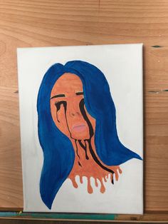 a drawing of a woman's face with blue hair and blood dripping from her mouth