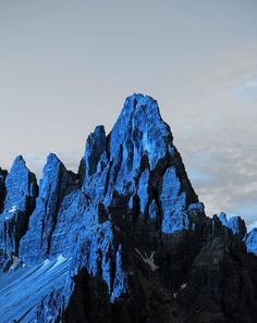 the mountains are covered in blue snow