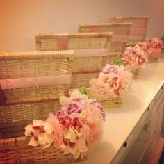 flowers are placed in wicker baskets on the counter