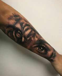 an arm with a tiger's eye on it and the bottom half of its arm