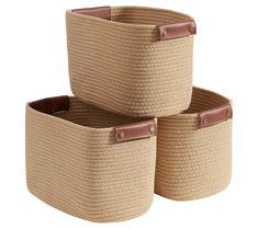 three woven storage baskets with leather handles