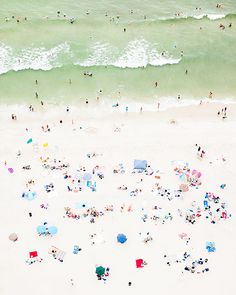 an aerial view of people on the beach and in the ocean with happy birthday banner