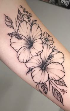 a black and white flower tattoo on the arm