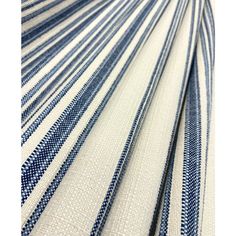 the blue and white striped fabric is folded on top of each other, with stripes