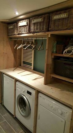 a washer and dryer in a laundry room with baskets on the shelves above