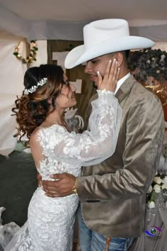 a man in a white cowboy hat and a woman in a wedding dress standing next to each other