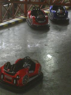 three bumper cars are lined up in a row