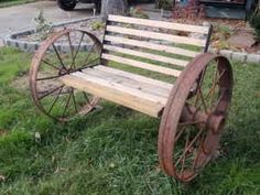 an old wooden bench sitting in the grass