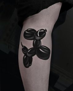 a black and white tattoo on the leg of a person