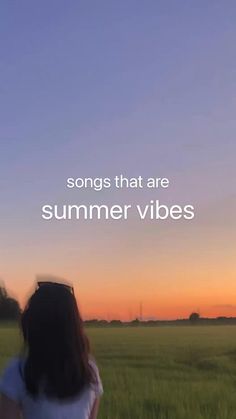 a woman standing in a field with the words songs that are summer vibes