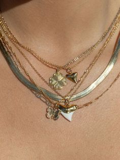 A tiny gold shark tooth pendant necklace. This gold shark tooth necklace is will bring a little Hawaii right to your doorstep. ✦ DETAILS ✦ ✧ Mano Petite - (mah NO) - shark. ✧ Gold vermeil shark tooth (gold plated sterling silver). ✧ 14kt gold filled chain. ✧ 14kt gold filled spring clasp. ✧ All Ke Aloha Jewelry pieces come packaged thoughtfully, beautifully, and ready for gift giving. ✦ OTHER NECKLACES SOLD SEPARATELY ✦ ✦ MORE SHARK TOOTH NECKLACES ➤ http://www.etsy.com/shop/kealohajewelry/searc Shark Tooth Necklace Gold, Shark Teeth Jewelry, Shark Jewelry, Shark Tooth Pendant, Tooth Charm, Tooth Pendant, Hawaii Jewelry, Shark Necklace, Butterfly Necklace Gold