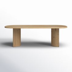 an oval wooden table sitting on top of a white floor