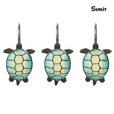 three sea turtle shaped lights hanging from hooks on a white background with the words, sunlit